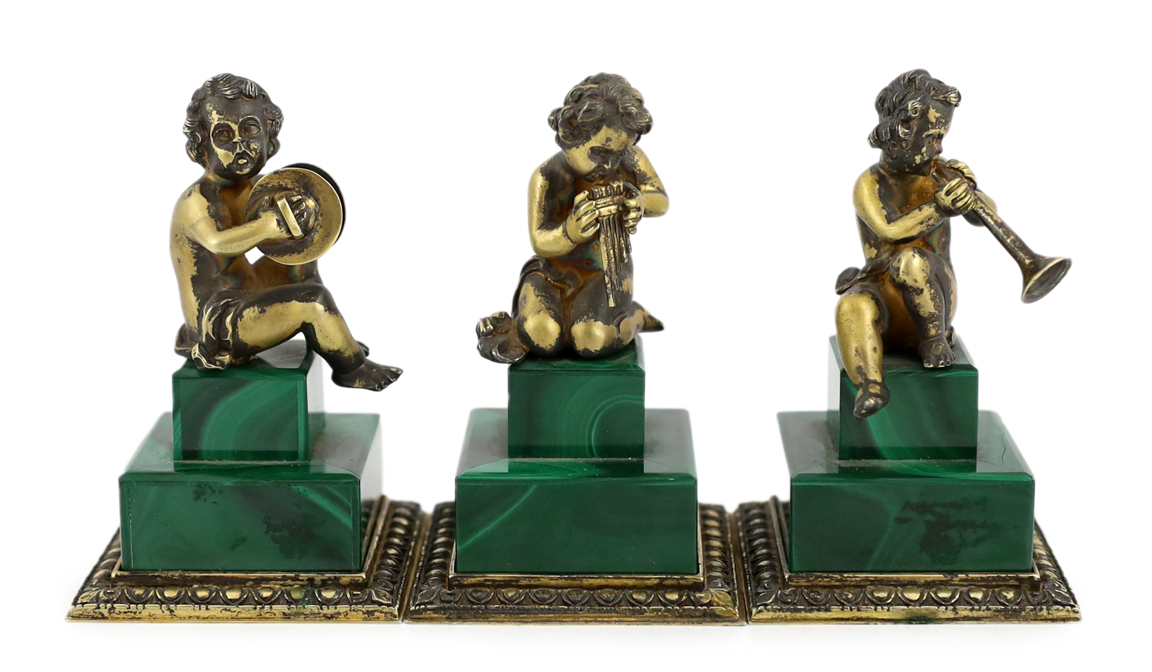 A set of three Italian silver gilt figures of musical putti, 5.5cm wide, 5.5cm deep, 9cm high